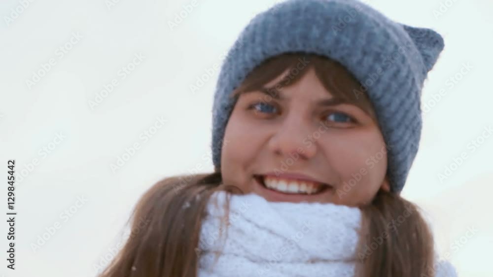 charming winter lady blowing a handful of snow right in the camera charming winter lady blowing a handful of snow right in the camera