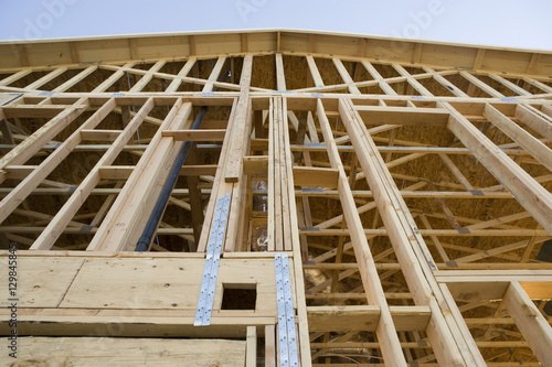 Low angle view of residential home framing under construction