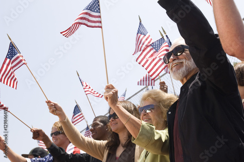 Multiethnic group of people with American flag during a rally © moodboard