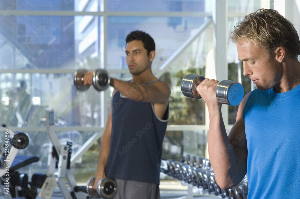 Handsome men lifting weights at a gym Handsome men lifting weights at a gym