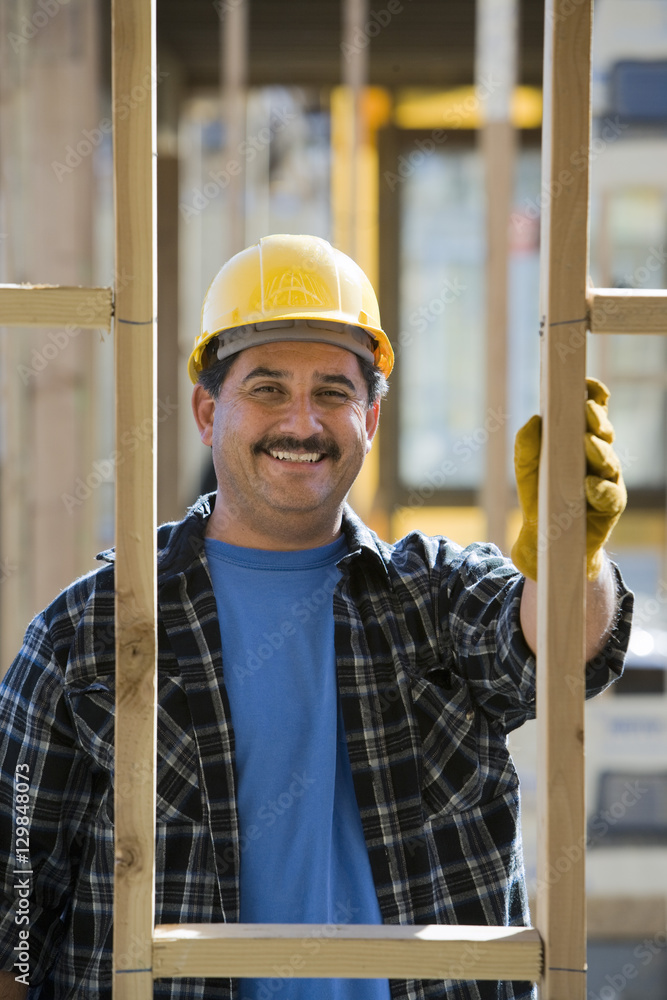 Portrait of mature Hispanic worker at construction site Portrait of mature Hispanic worker at construction site