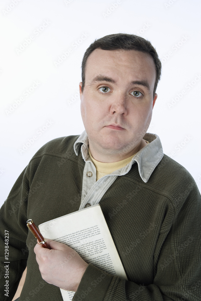 Portrait of middle aged man holding pen and a book isolated over white background Portrait of middle aged man holding pen and a book isolated over white background