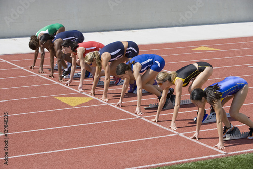 Bilde på lerret Group of multiethnic female athletes at starting line ready to race