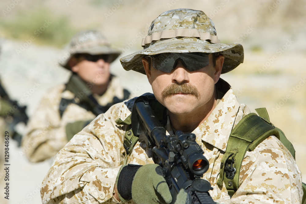 Confident soldiers with sniper rifles on a mission Confident soldiers with sniper rifles on a mission
