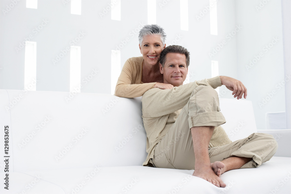 Obraz premium Portrait of happy mature couple relaxing in living room