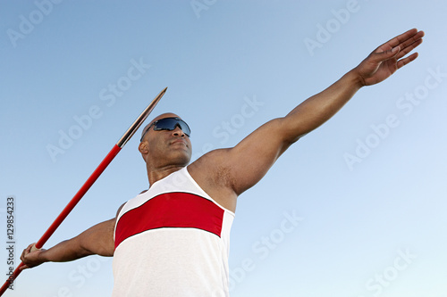 Athlete about to throw javelin half length