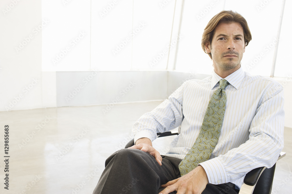 Portrait of a mature businessman sitting in office Portrait of a mature businessman sitting in office