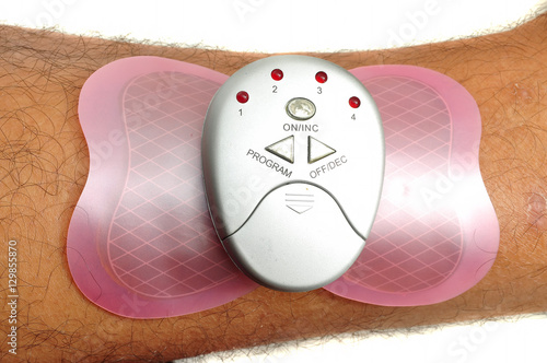 Electronic massager on human leg photo