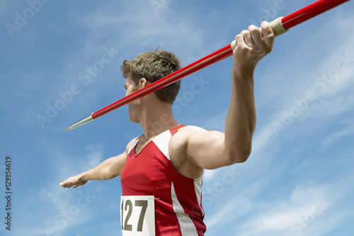 Photos Male athlete about to throw javelin against the sky