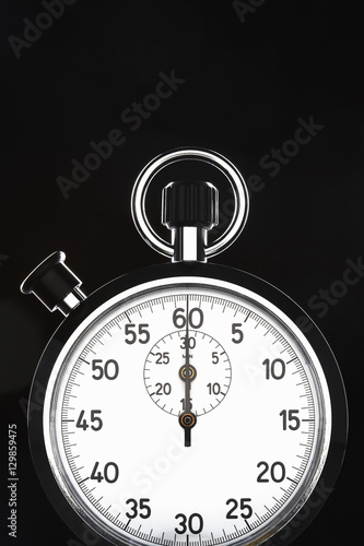 Closeup of stopwatch over black background