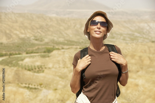 Portrait of beautiful female hiker standing on top of mountain