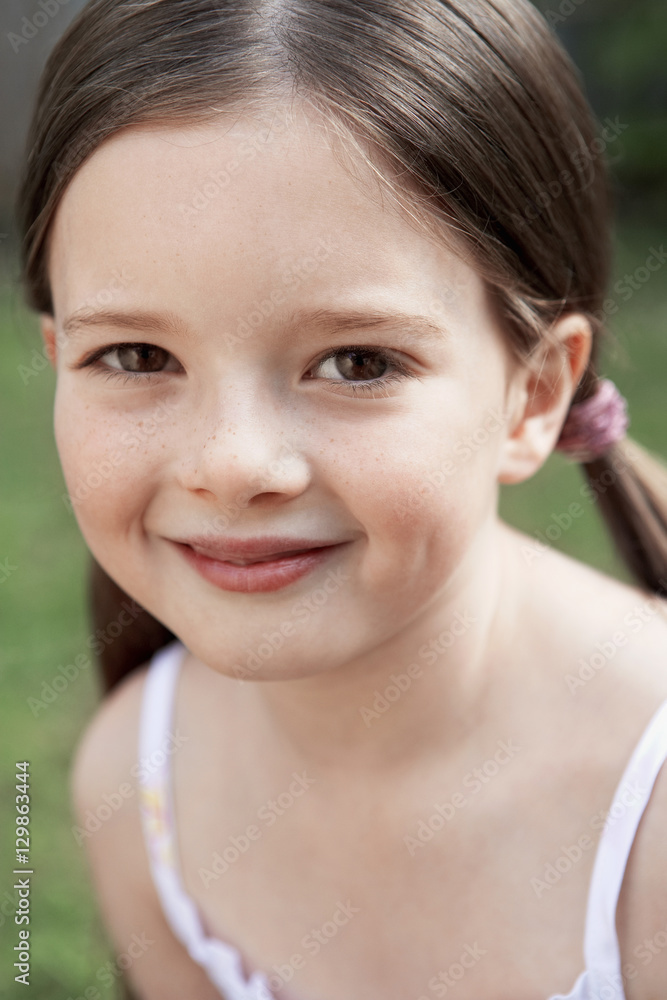 Closeup portrait of smiling young girl in park Closeup portrait of smiling young girl in park