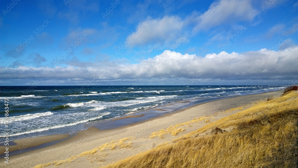 Gorgeous views of the Baltic sea on a bright Sunny cloudy weather with beautiful sand and waves