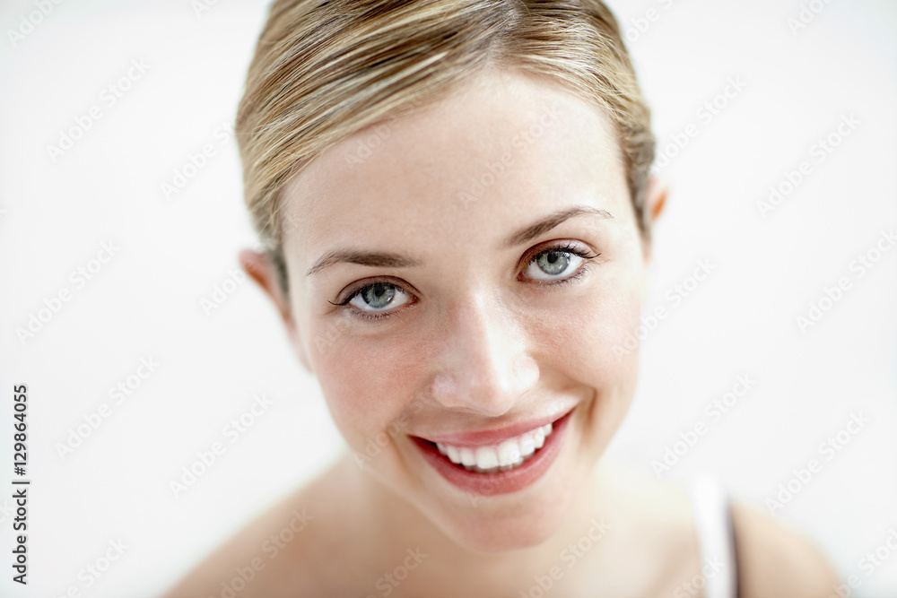 Closeup portrait of young woman smiling isolated on white background Closeup portrait of young woman smiling isolated on white background