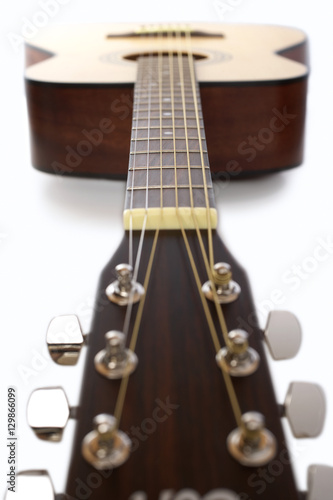 Acoustic guitar over white background
