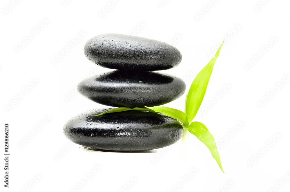 Zen stone with bamboo leaf on white background. Spa concept Zen stone with bamboo leaf on white background. Spa concept