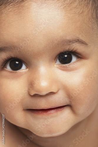 Closeup of cute baby boy looking up © moodboard