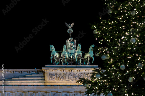 A fragment of the Brandenburg Gate  Quadriga close-up  and a fragment of a Christmas tree in the foreground.