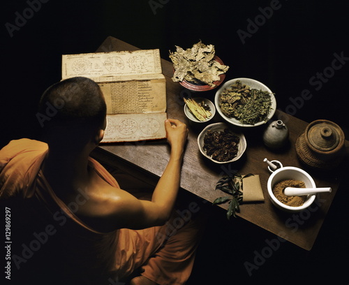Thai monk preparing herbal medicines photo