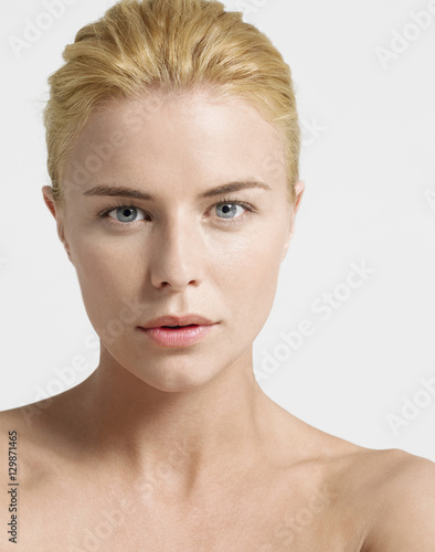 Closeup of a seductive young woman over white background