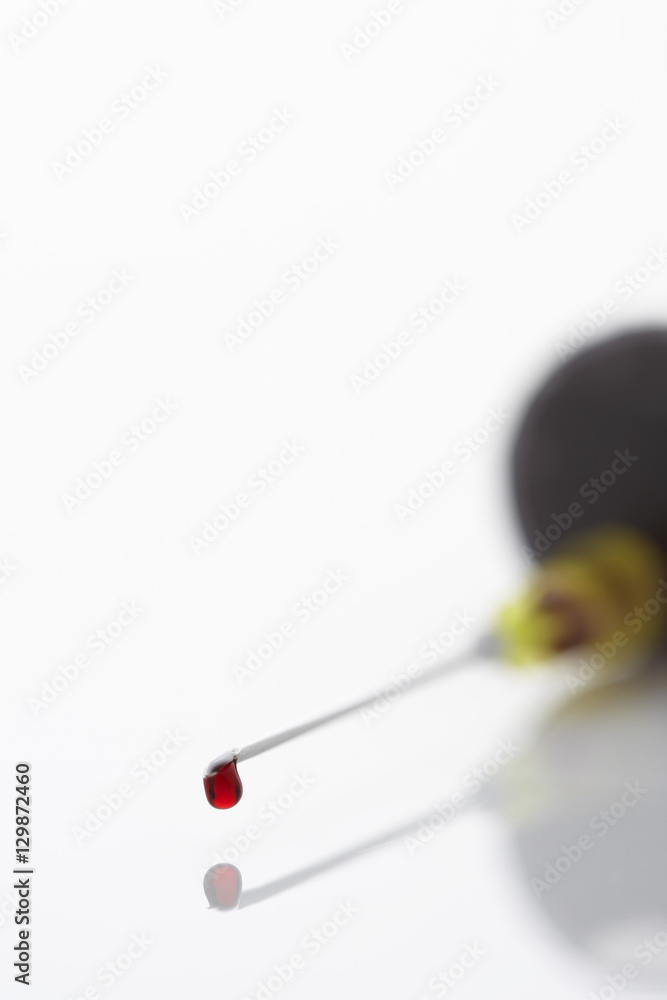 Blood droplet on syringe close-up Blood droplet on syringe close-up