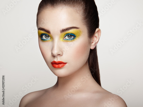 Beautiful woman face. Perfect makeup. Beauty fashion. Eyelashes. Cosmetic Eyeshadow. Elegant hairstyle.