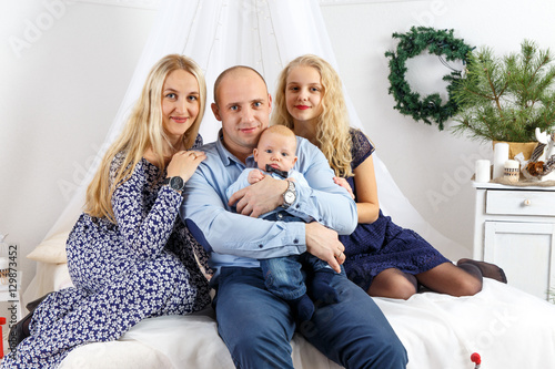 Happy family sitting on bed