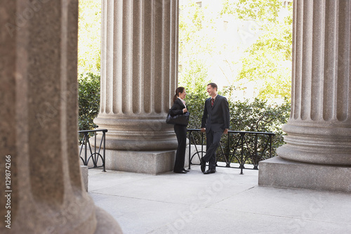 Tableau sur toile Full length of two attorneys talking outside courthouse