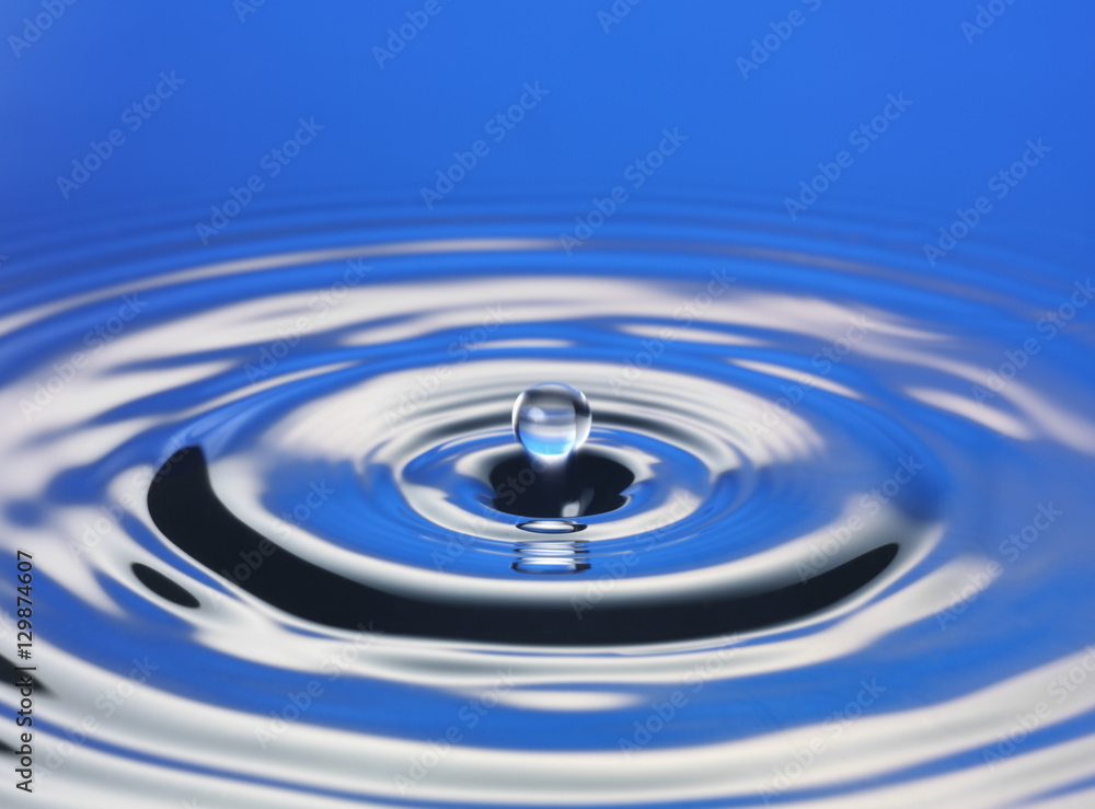 Drop hitting surface of water close-up Drop hitting surface of water close-up
