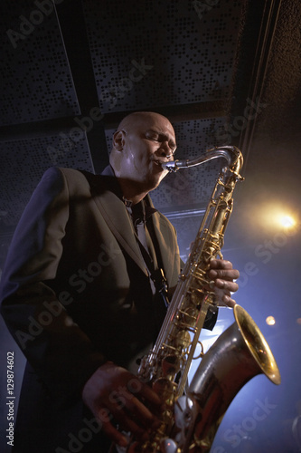 Low angle view of a musician playing saxophone in the jazz club