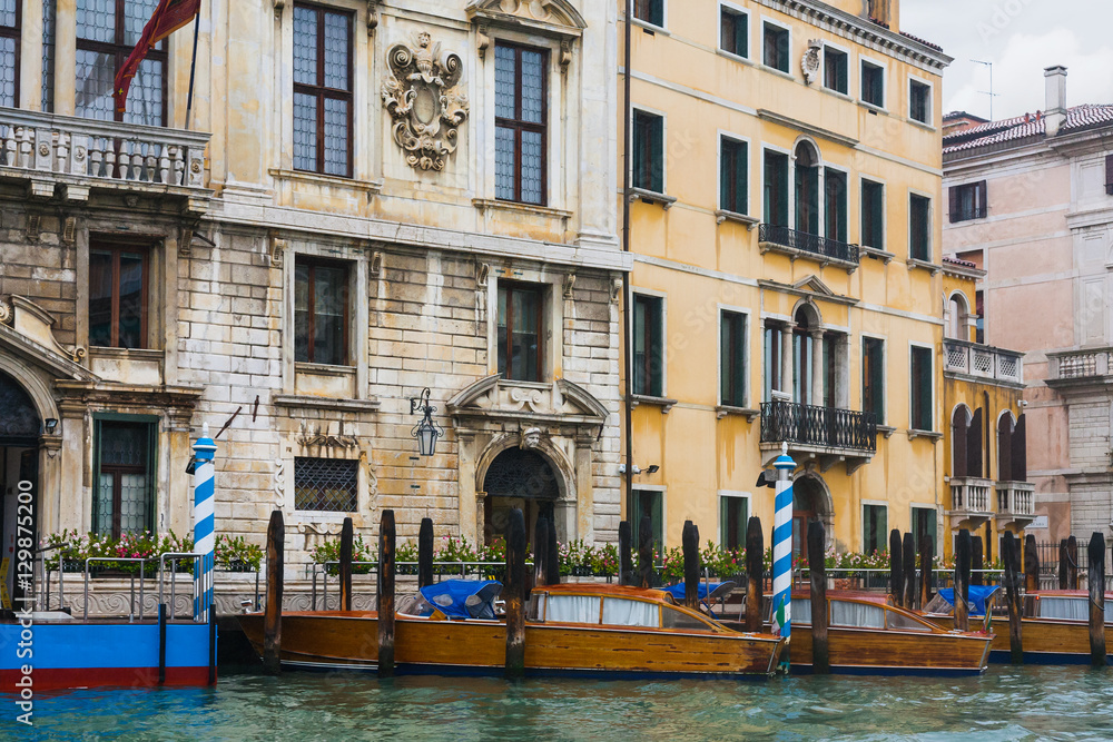 mooring water taxi near houses in Venice in rain