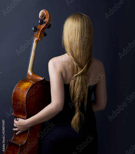 
Beautiful girl with a cello in the dark. Violonchello. Girl with long straight hair
 photo