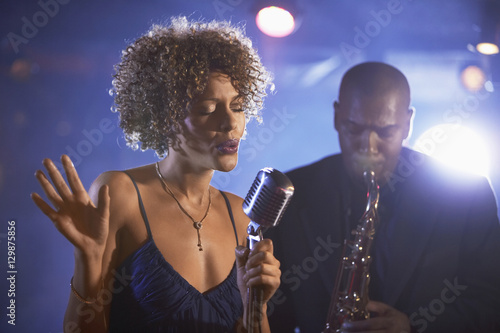 Female singer and saxophonist performing at the jazz club