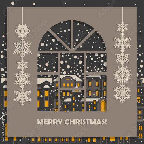 Concept for New Year square vintage postcard. Gray paper with carved arched window and white snowflakes. City at night with falling snow and glowing windows in the background.