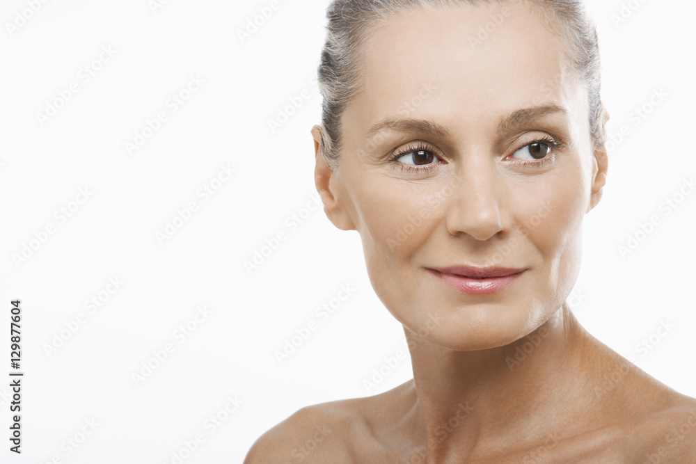 Closeup of happy middle aged woman looking away isolated on white background Closeup of happy middle aged woman looking away isolated on white background