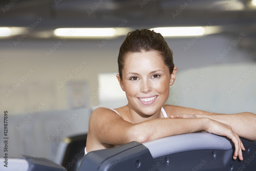 Portrait of beautiful young woman resting on treadmill at health club Portrait of beautiful young woman resting on treadmill at health club