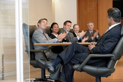 Multiethnic business people applauding boss in office meeting