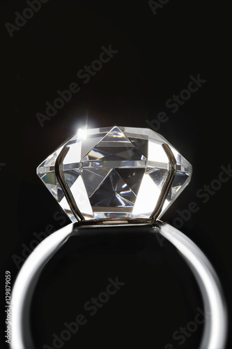 Closeup of diamond ring isolated over black background