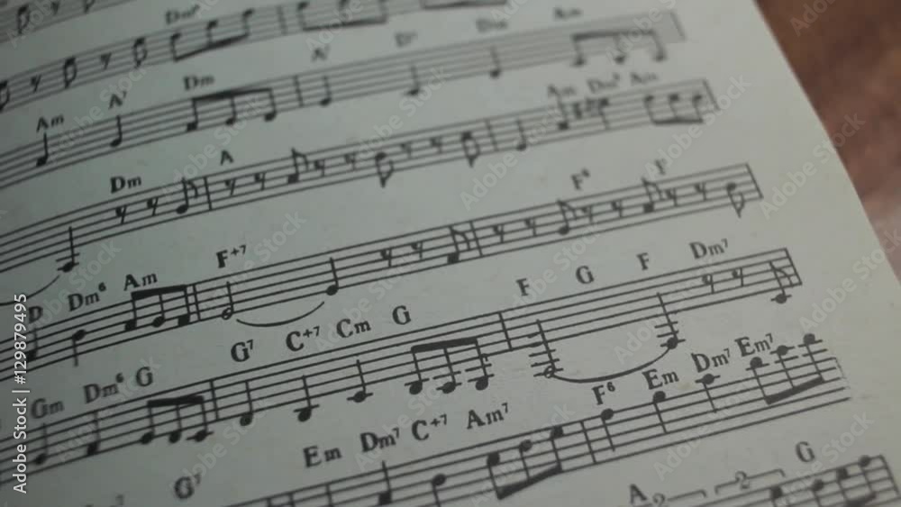 Book of musical notes of classical pieces on the table in the classroom panoramic shot Book of musical notes of classical pieces on the table in the classroom panoramic shot