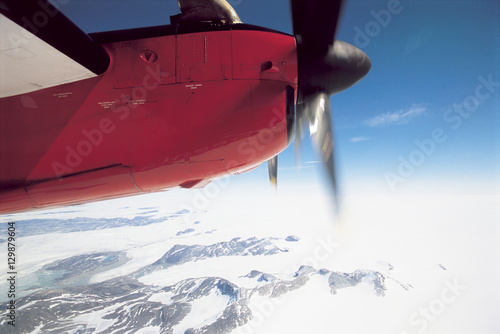 Plane flying over snowy landscape