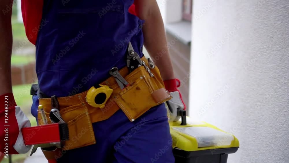 handyman services - worker with tool box going to client house