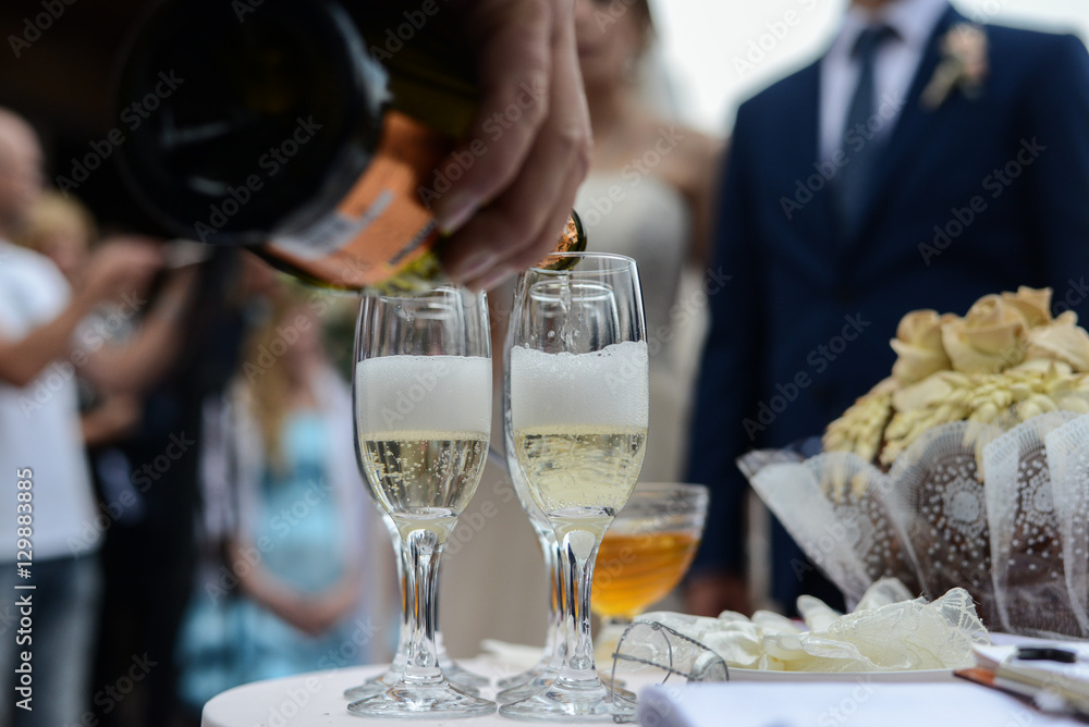 Pouring champagne into a glass on a wedding celebration