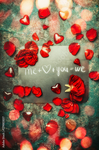 Valentines day greeting card with red roses , heart and text you and me we, top view composing. Love and dating concept