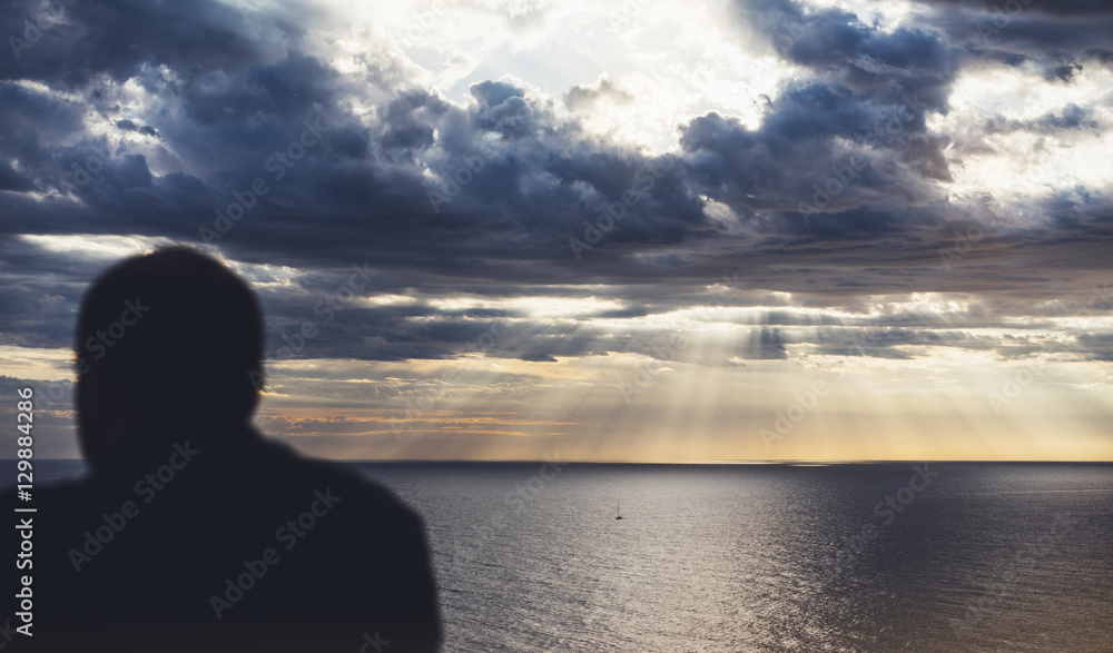 Clouds blue sky and sunlight sunset on horizon ocean Northern. Outline looking travel hipster on background seascape dramatic rays sunrise. Relax view waves sea, mockup nature concept.