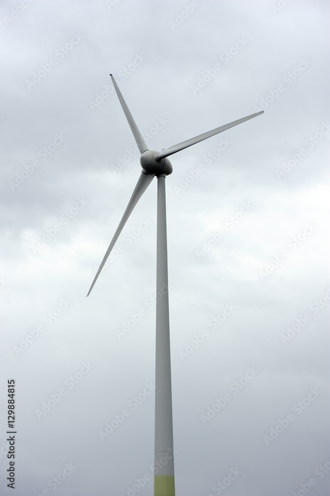 Tower and blades Wind power generator on a background cloudy sky Tower and blades Wind power generator on a background cloudy sky