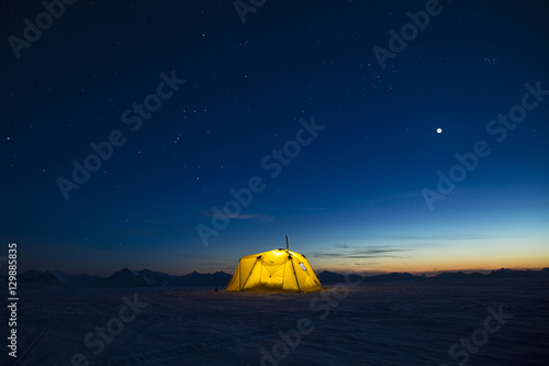 Camping on the snow at night in the mountains