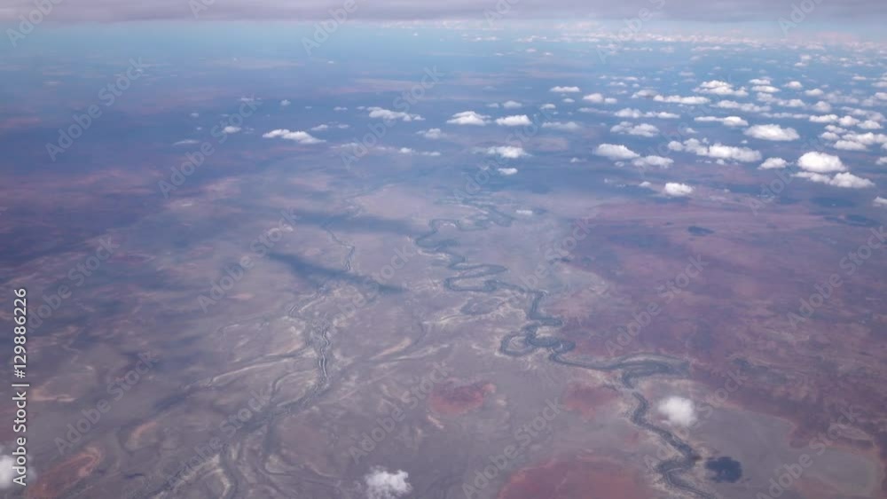 AERIAL: Flying high above bend watercourse of river in arid desert landscape AERIAL: Flying high above bend watercourse of river in arid desert landscape