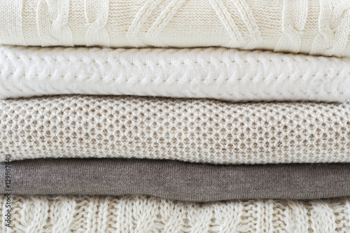 Stack of warm knitted sweaters