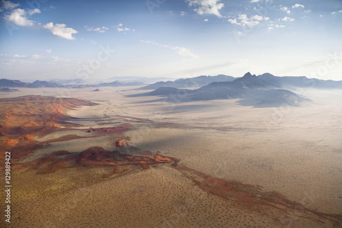 Aerial view from hot air balloon over magnificent desert landscape of sand dunes, mountains and Fairy Circles, Namib Rand game reserve Namib Naukluft Park, Namibia