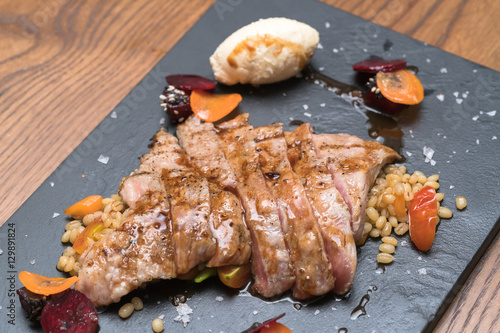 pork steak with vegetable on a granite plate

